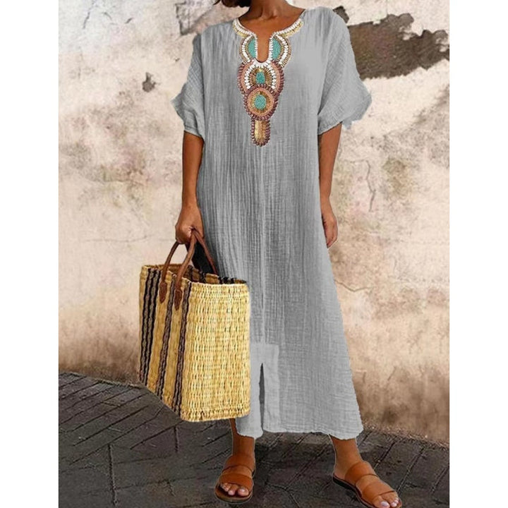 Close-up view of embroidered neckline detail on Summer Maxi Dress showing decorative stitching and V-neck opening