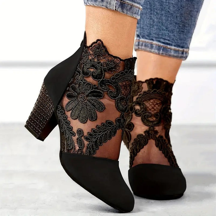 Side profile of burgundy lace ankle heels showing block heel and intricate floral embroidery detail