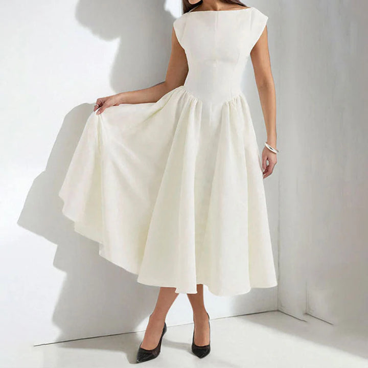 Woman wearing cap sleeve fit and flare midi dress in cream white with round neckline and full skirt