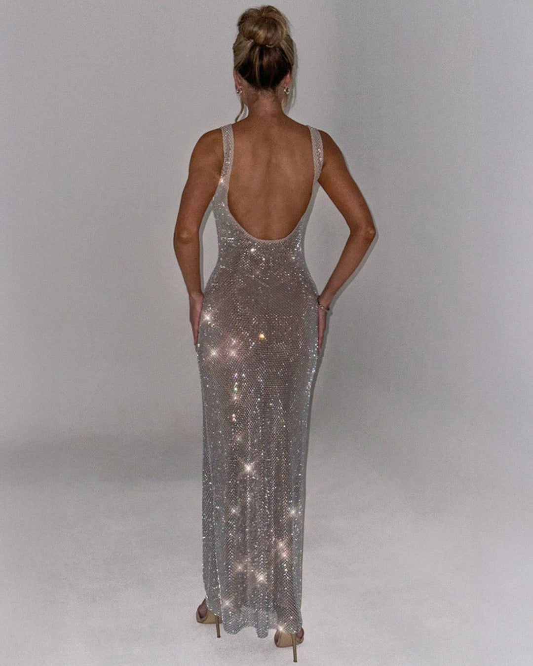 Close-up of strap detailing and square neckline on embellished burgundy evening gown
