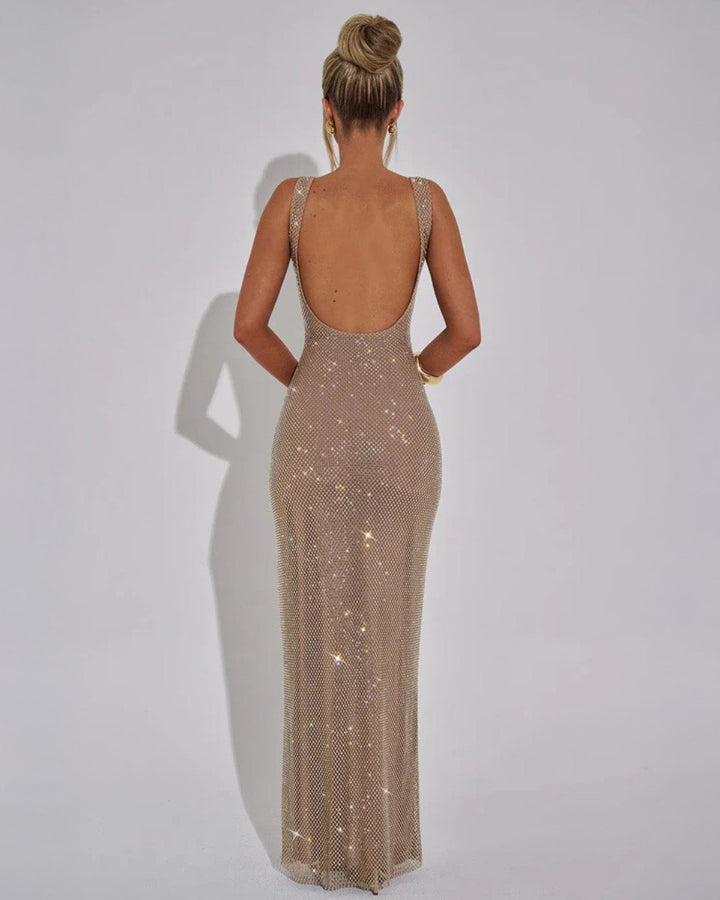 Model in burgundy embellished evening gown showing graceful movement and floor-length design