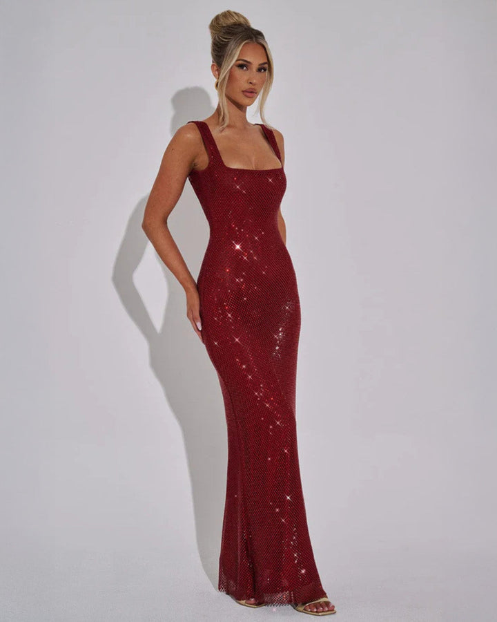 Side angle of floor-length embellished gown showing slim body-contouring fit and graceful drape