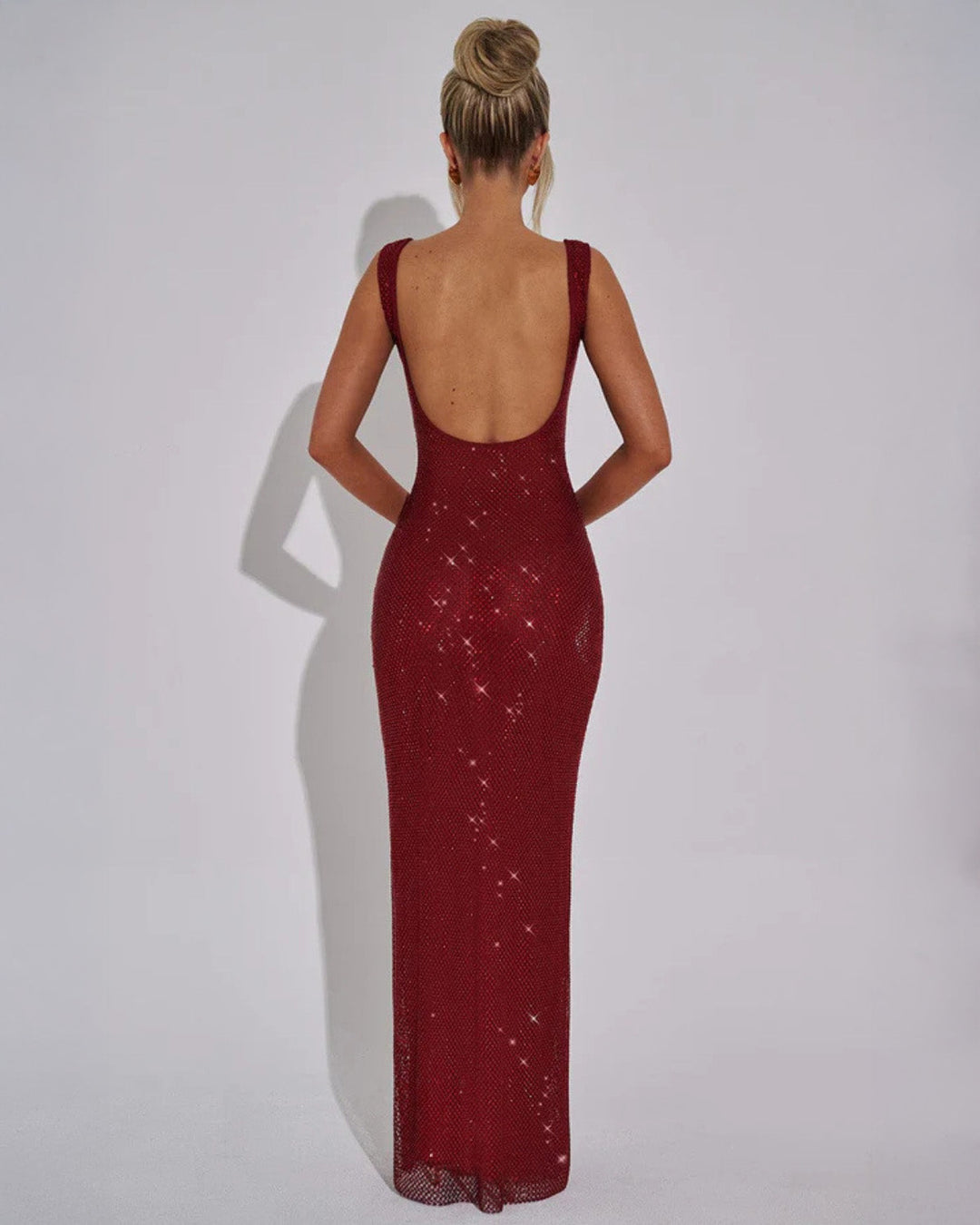 Back view of burgundy evening gown with delicate straps and all-over embellishment detail
