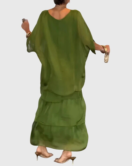 Side view showing flowing tiered silhouette of womens boho maxi dress with green top