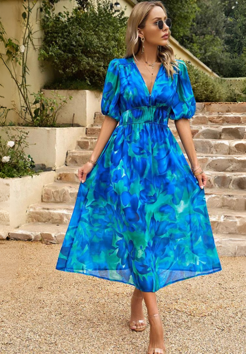 Back view of Women's Abstract Print Midi Dress showing V-neckline and flowing skirt drape