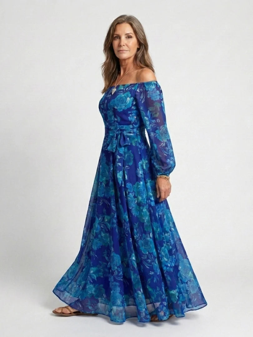 Off-shoulder maxi dress featuring vibrant teal and blue floral pattern with adjustable waist tie