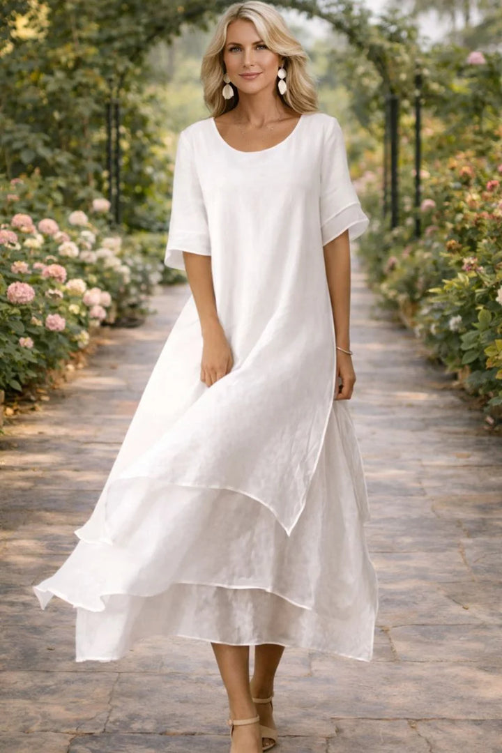 Close-up view of the tiered hem and flowing silhouette of the women's dress with open neckline