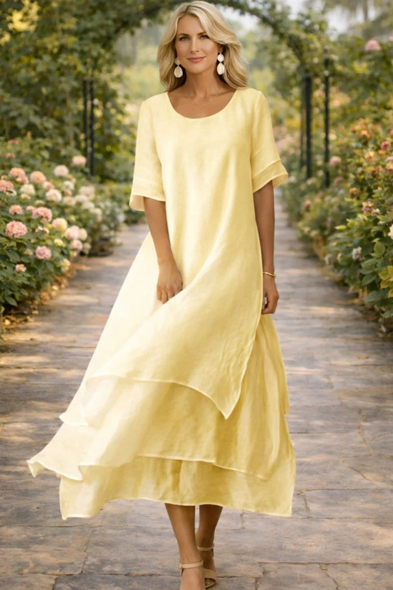 Side angle showing the relaxed fit and flutter sleeves of the layered midi dress