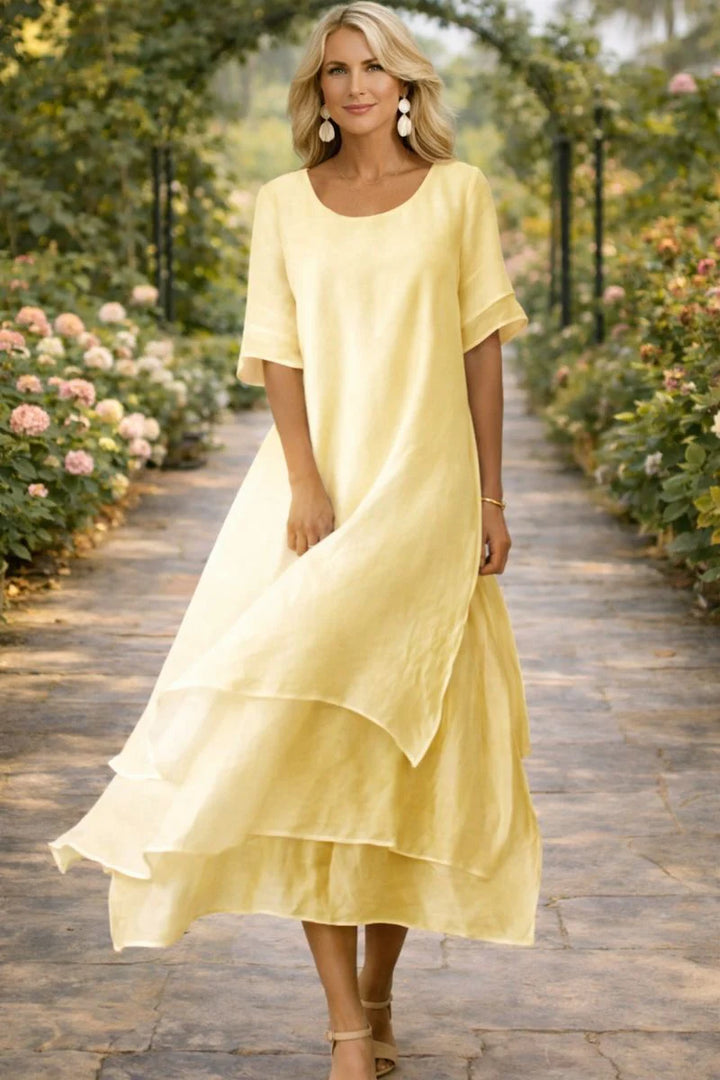 Side angle showing the relaxed fit and flutter sleeves of the layered midi dress