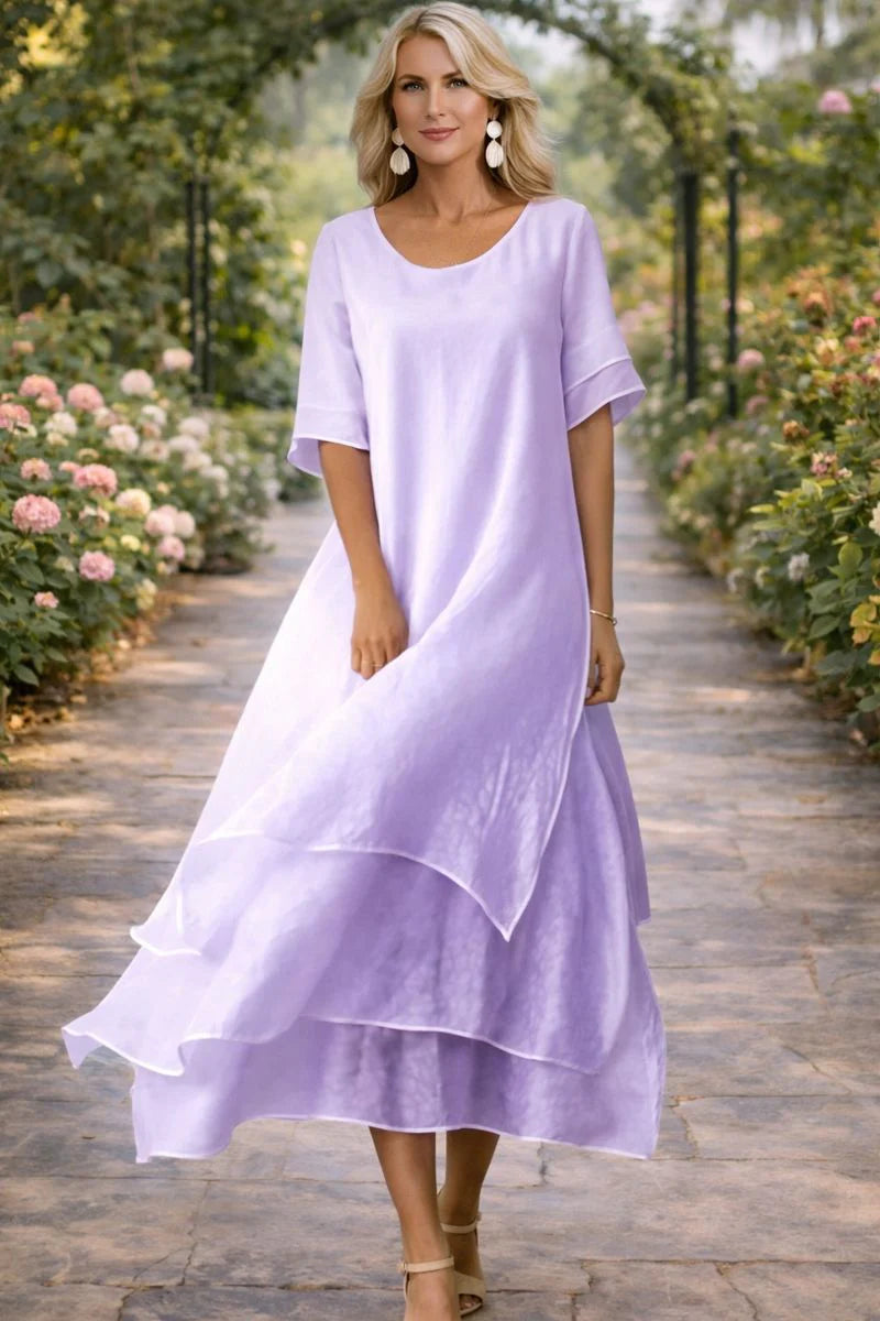 Detail of the scoop neckline and soft draping fabric on the flattering cut dress