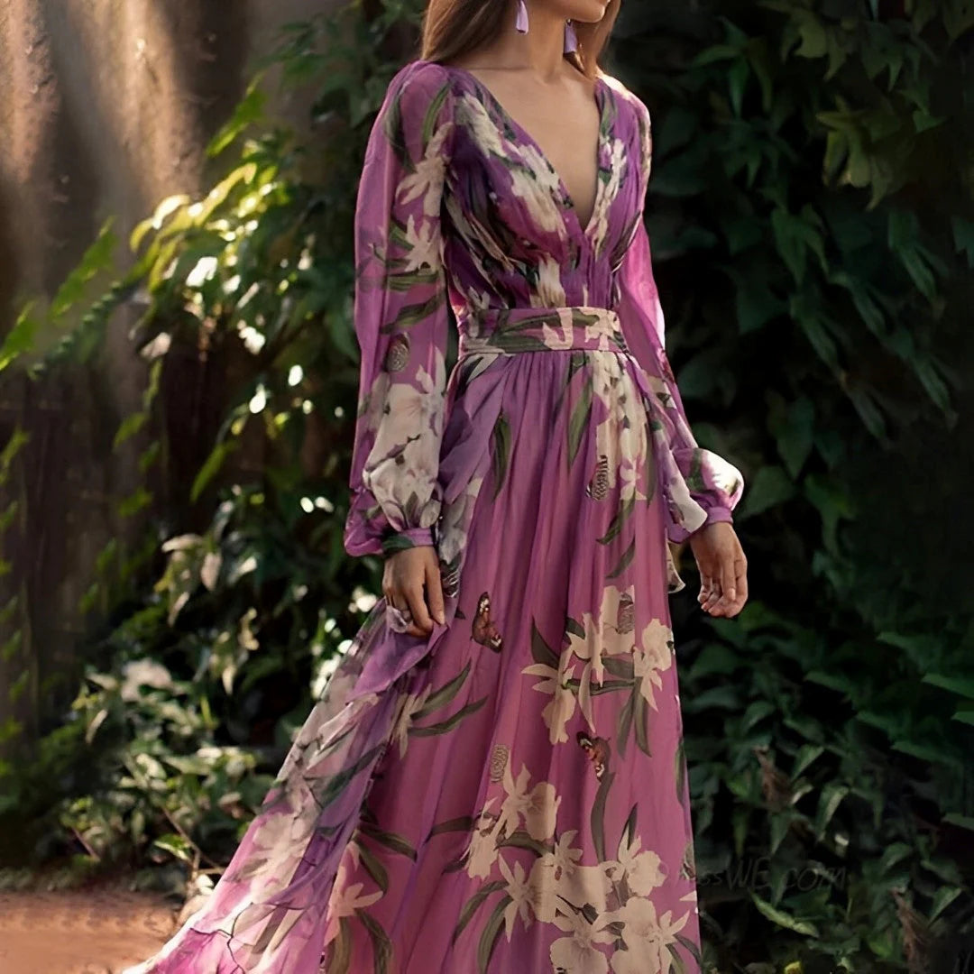 Side view of flowy maxi dress showing full-length skirt with large-scale floral motifs and long sleeves