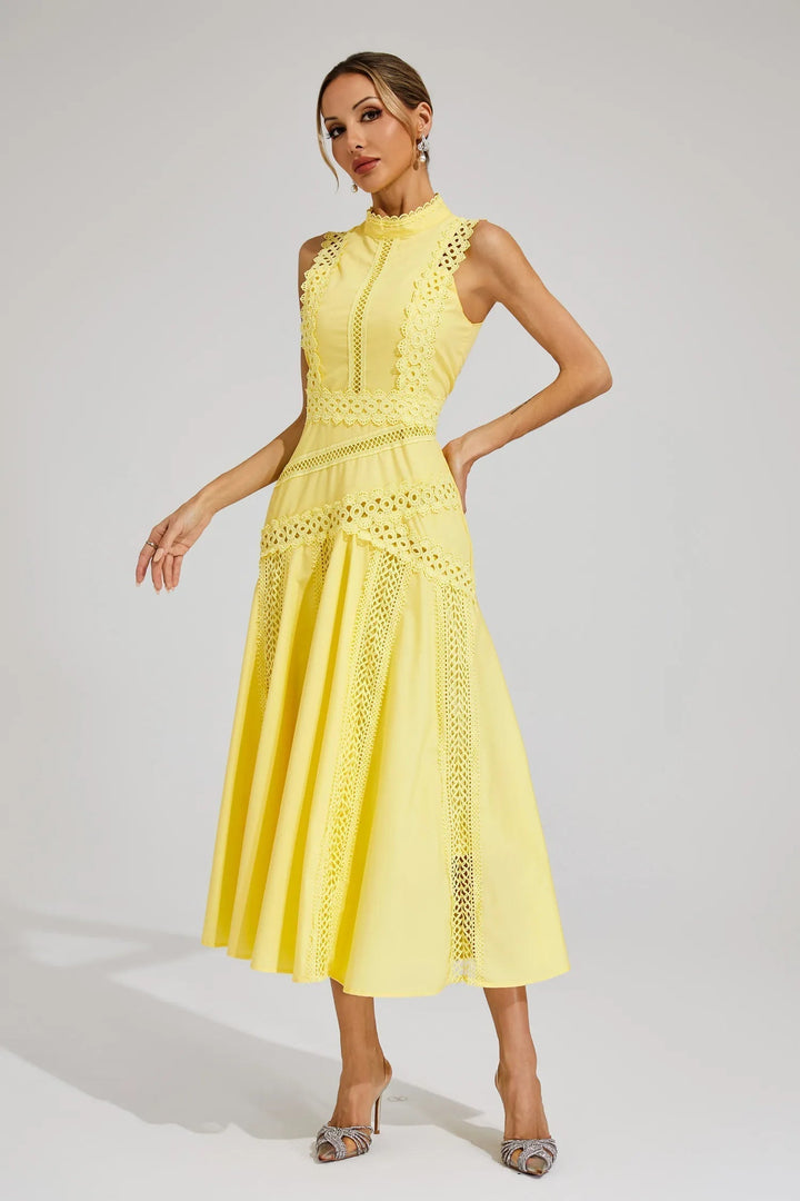 Side view of sleeveless lace midi dress with flowing skirt and decorative waist detail