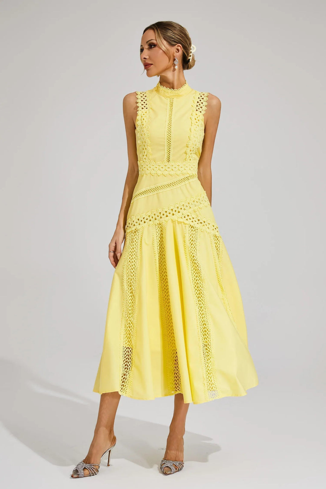 Detail of intricate lace inserts on midi wedding guest dress bodice and skirt