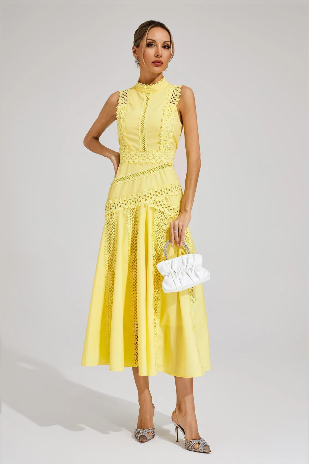 Back view of sleeveless lace midi dress showing elegant silhouette and flared hem
