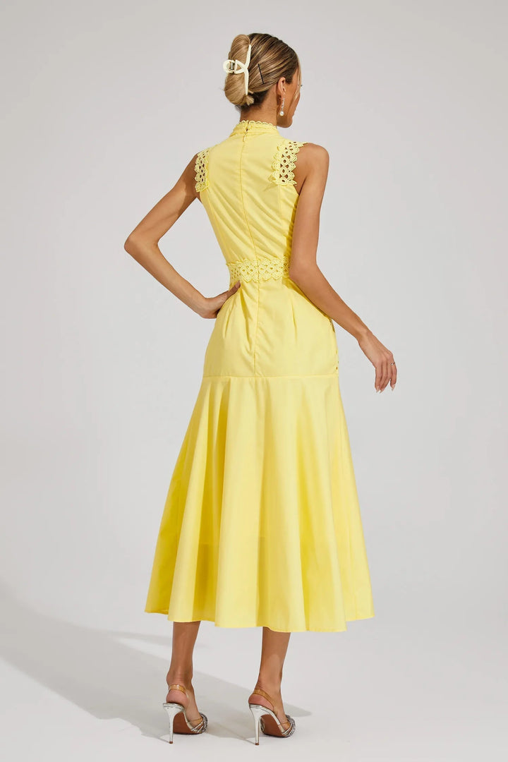 Women's sleeveless lace midi wedding guest dress styled with heeled sandals for occasion wear