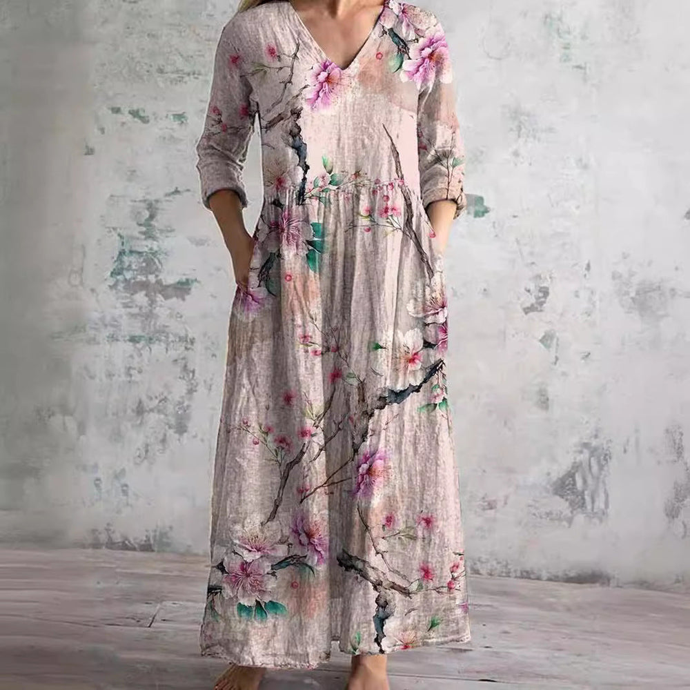 Close-up view of V-neckline and floral pattern detail on women's summer maxi dress with textured fabric