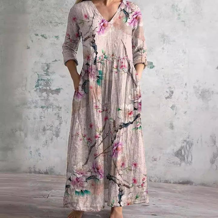 Close-up view of V-neckline and floral pattern detail on women's summer maxi dress with textured fabric