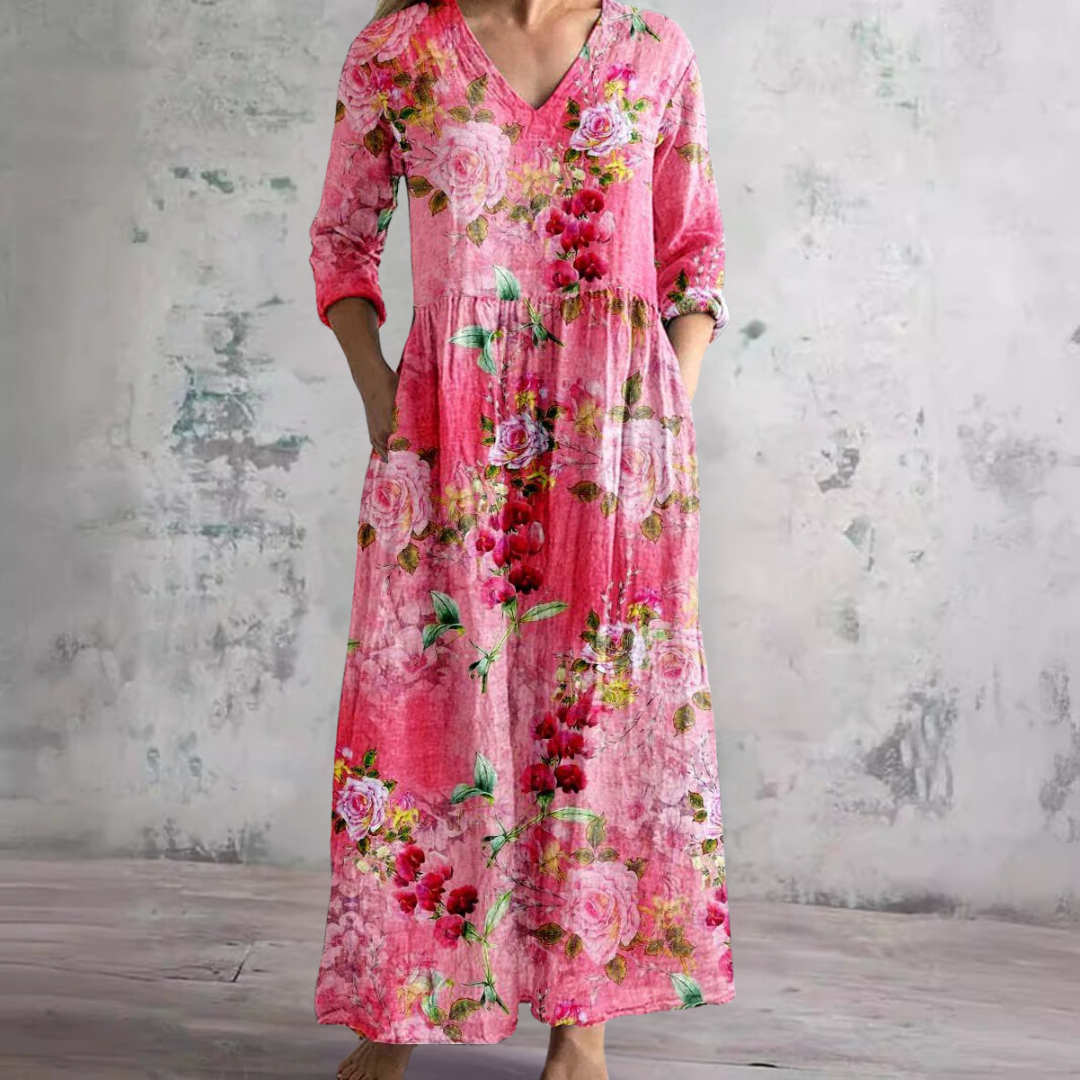 Full-length view of women's floral maxi dress with V-neck, three-quarter sleeves, and trailing rose pattern