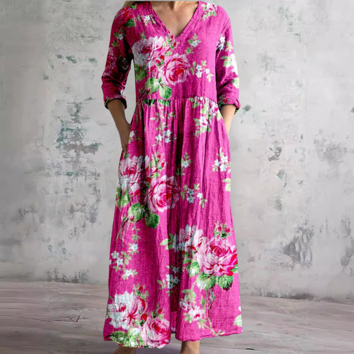 Back view of women's V-neck summer dress showing relaxed maxi silhouette and botanical rose print