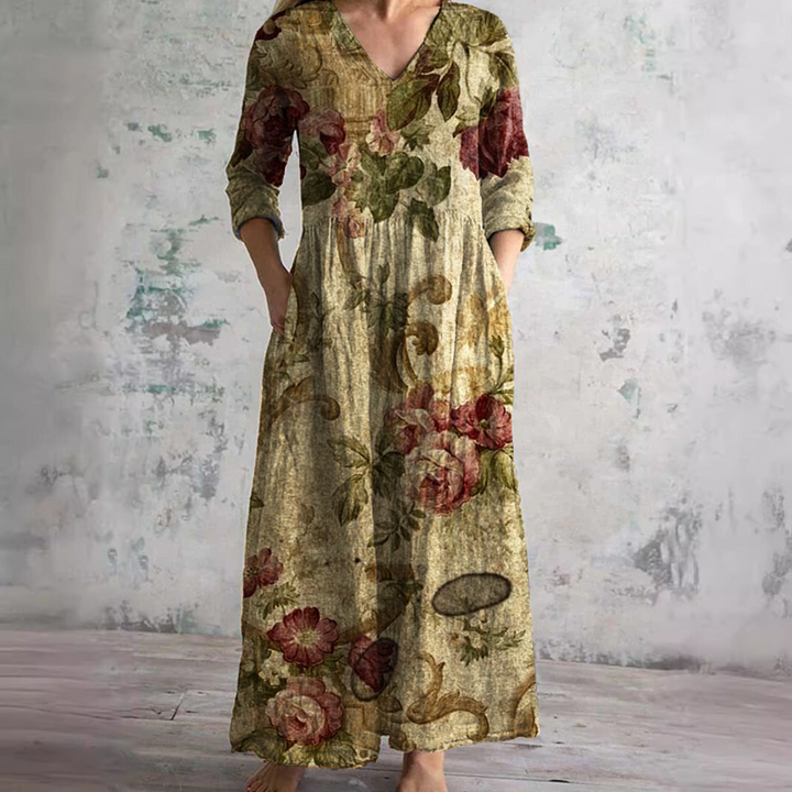 Close-up of three-quarter sleeve detail and rose print on women's summer dress with textured fabric