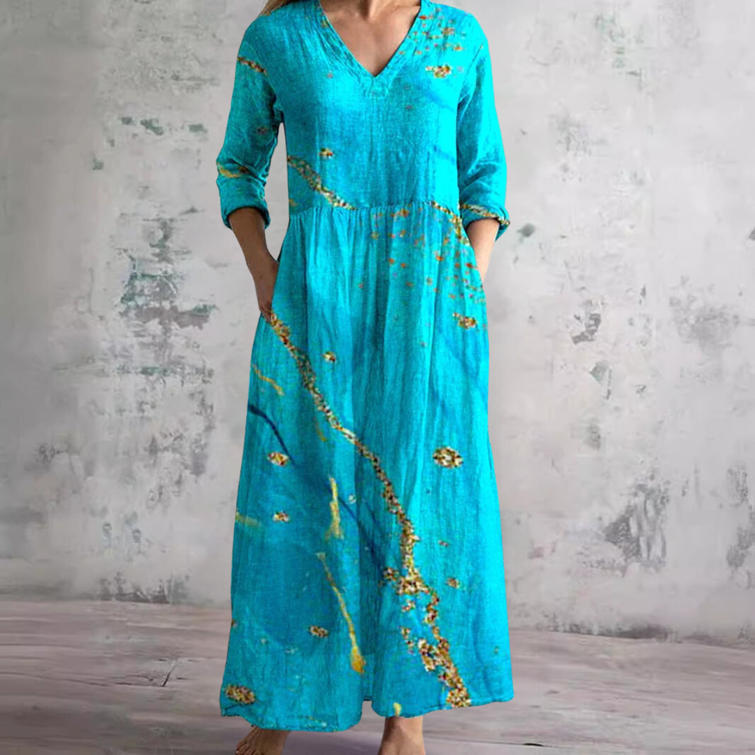 Women's floral maxi dress showing gathered waist detail and V-neckline with botanical print