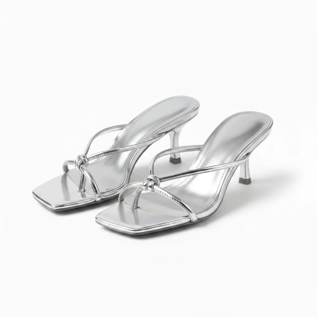Full view of women's heeled sandals showing slip-on construction and mid-height heel