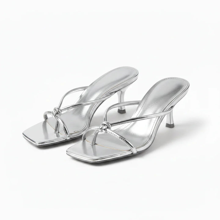 Full view of women's heeled sandals showing slip-on construction and mid-height heel