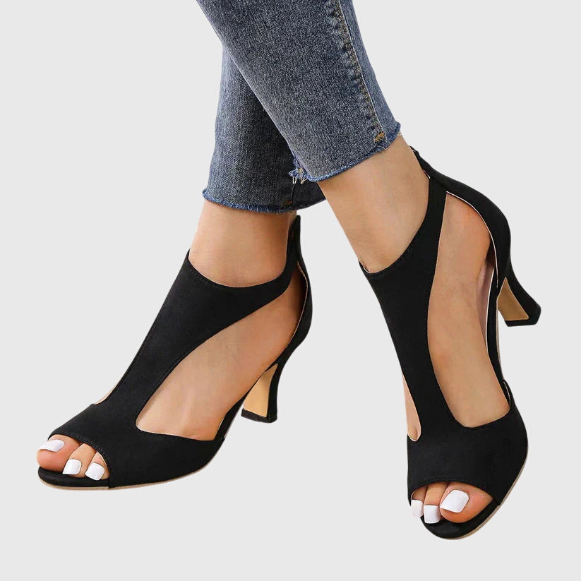Detail shot of orthopedic heels showing smooth finish and secure zip fastening at ankle strap