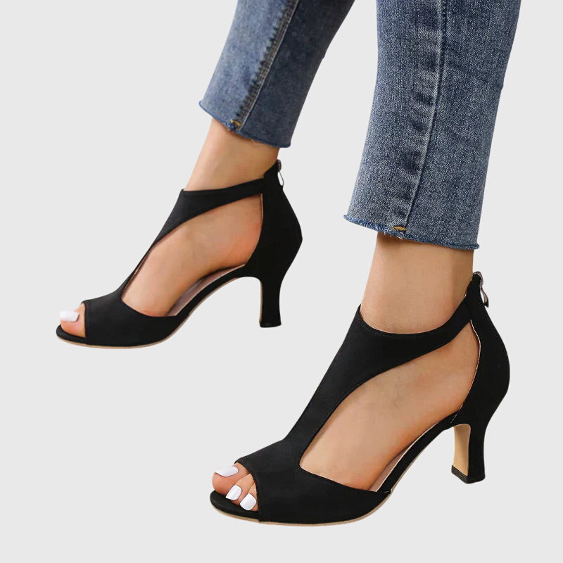 Orthopedic peep toe heels worn with denim showcasing comfortable lift and stable heel base