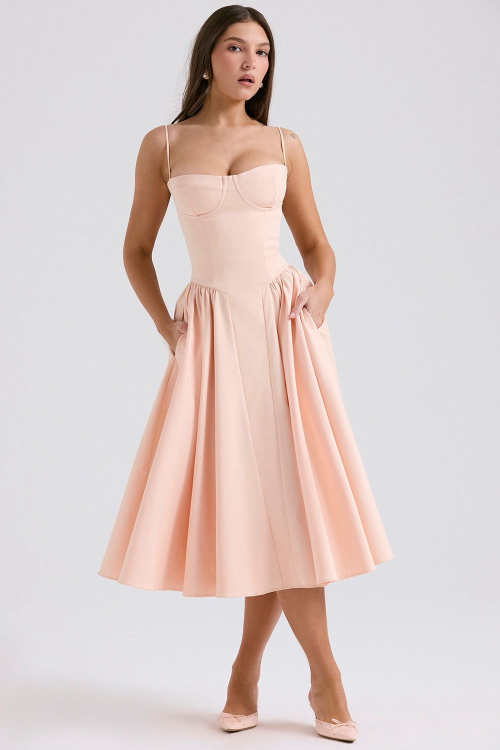 Side profile showing the structured bodice and flowing gathered midi skirt of corset dress