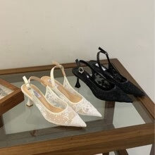 Side view of women's pointed toe lace heels with sculptured mid-height heel