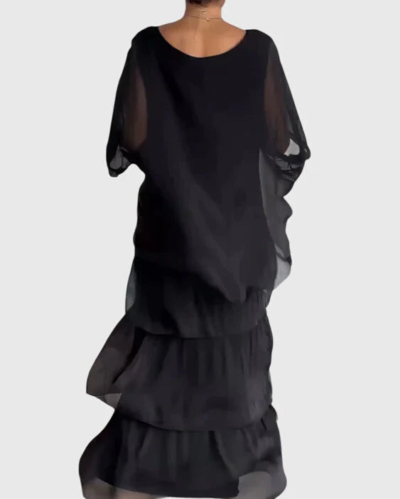 Front view of boho layered maxi dress featuring flowing three-tier skirt with bold colour blend