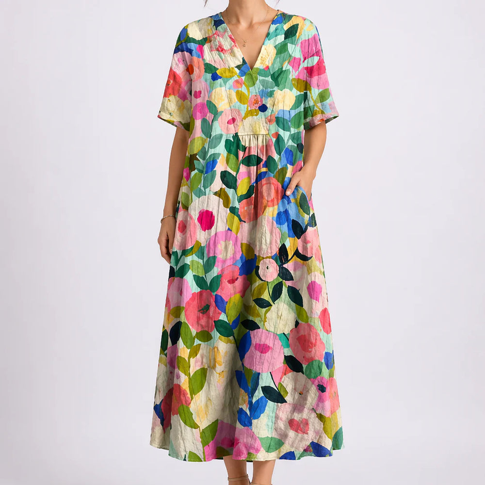 Close-up of floral midi dress showing gathered waist and flowing skirt detail