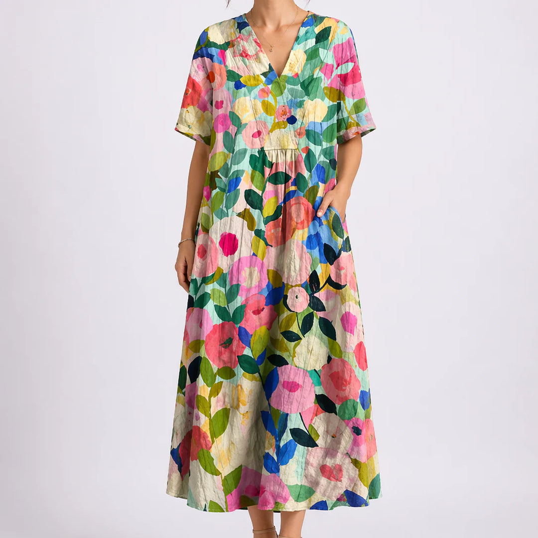 Close-up of floral midi dress showing gathered waist and flowing skirt detail