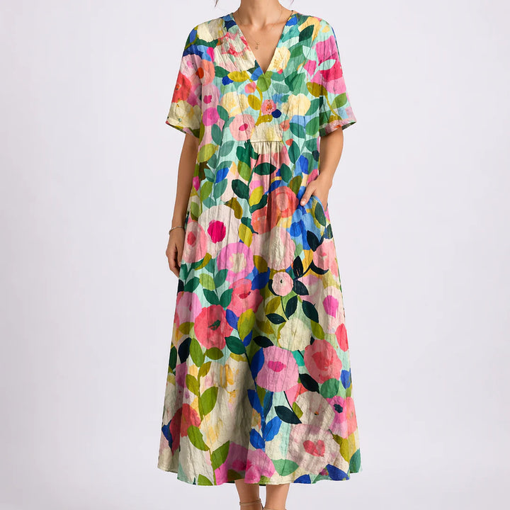 Close-up of floral midi dress showing gathered waist and flowing skirt detail