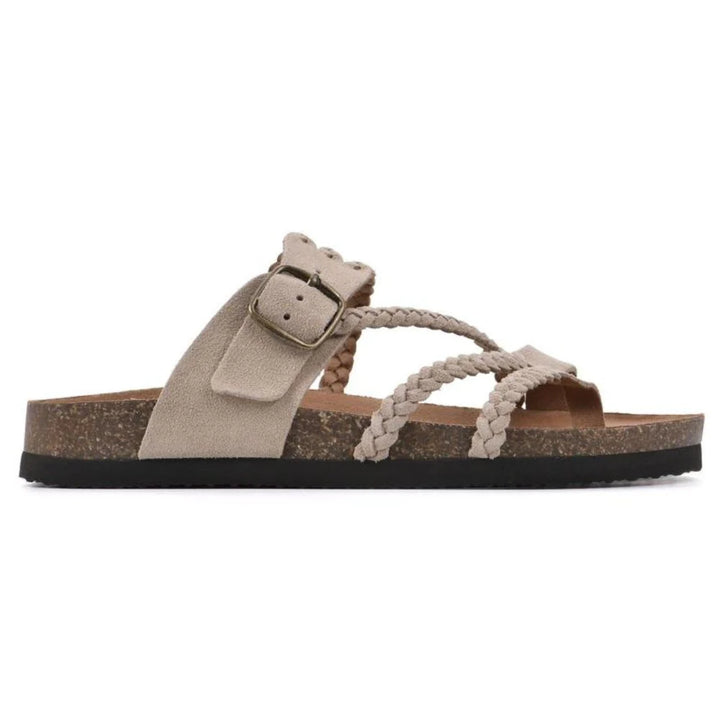 Close-up of plaited straps and contoured cork sole on women's buckle sandals