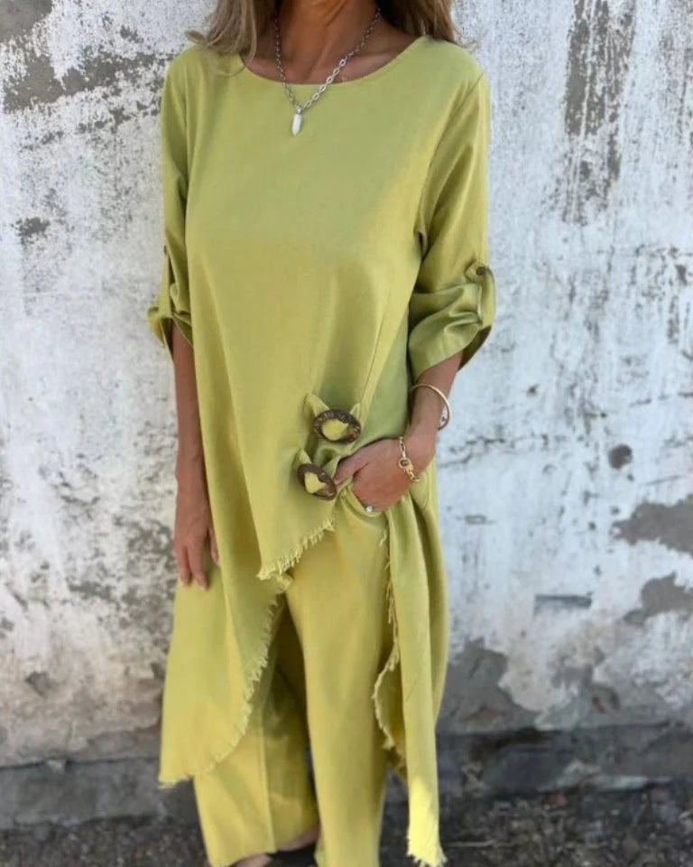 Close-up view of the relaxed fit top with boat neck and button detail on sleeves