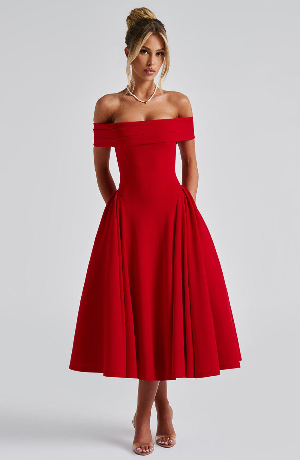Olivia wearing the Off-Shoulder Flare Midi Dress in red with folded neckline and flared skirt