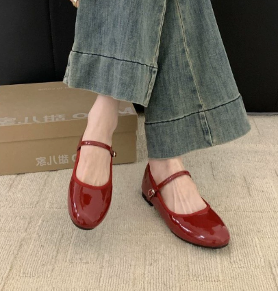 Side view of women's orthopaedic Mary Jane shoes showing secure ankle strap and classic silhouette worn with grey trousers