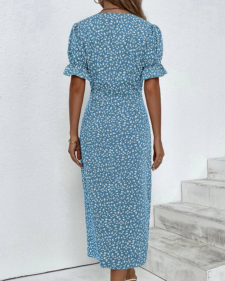 Detail shot of floral print pattern on green wrap dress with white ditsy floral motif