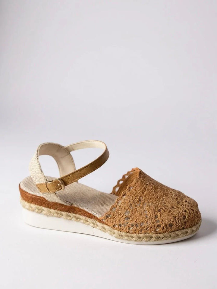 Close-up of crochet woven espadrille platform sandals showing intricate artisanal detailing and buckle fastening