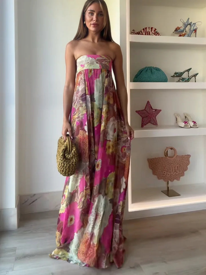 Strapless floral maxi dress in vibrant magenta and coral print with flowing floor-length skirt