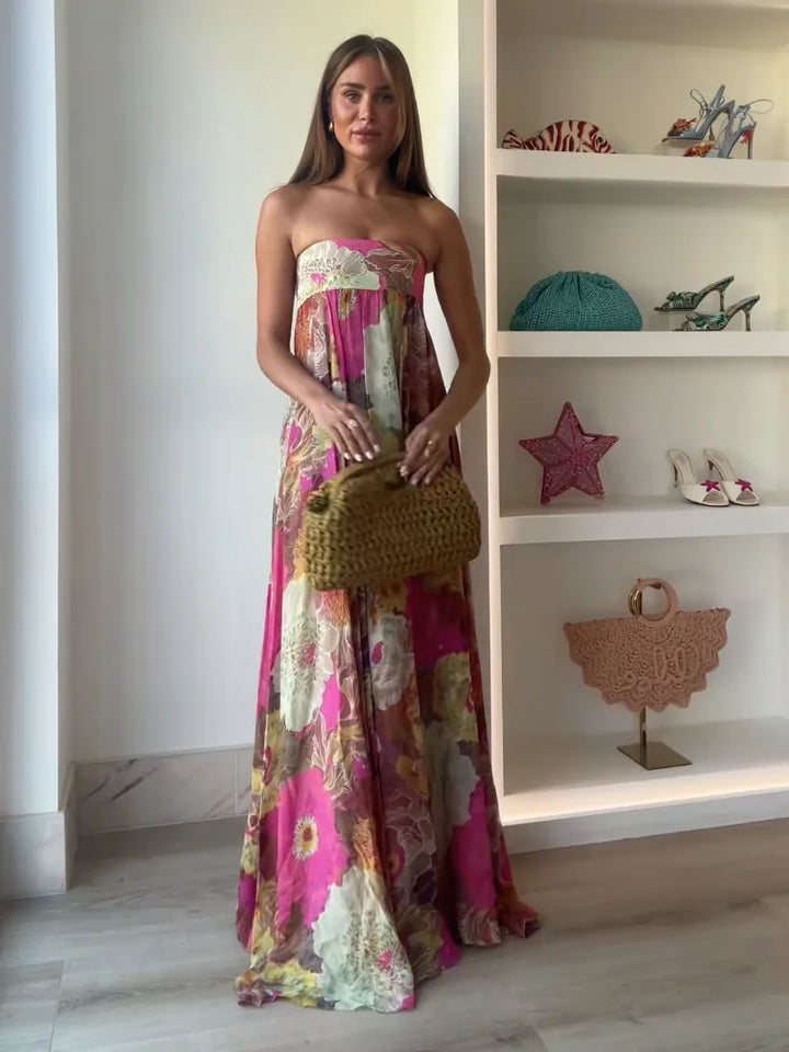 Side view showing flowing silhouette and floor-length hem of strapless floral maxi dress