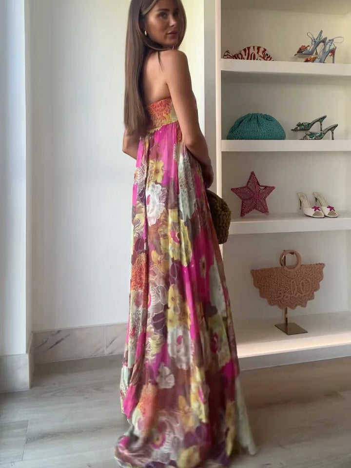 Full-length view of floral maxi dress styled with woven bag for summer occasions