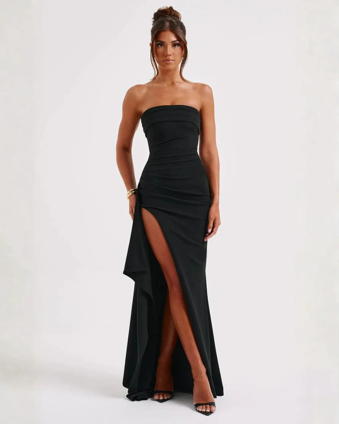 Strapless ruched maxi dress in black with thigh-high split and cascading ruffle detail for formal occasions