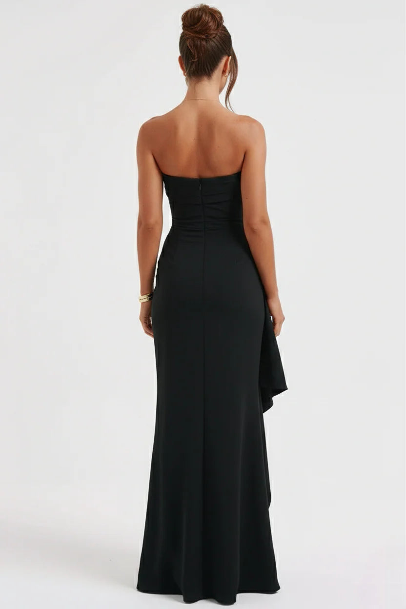 Side view of strapless maxi dress displaying dramatic thigh-high split with cascading ruffle accent