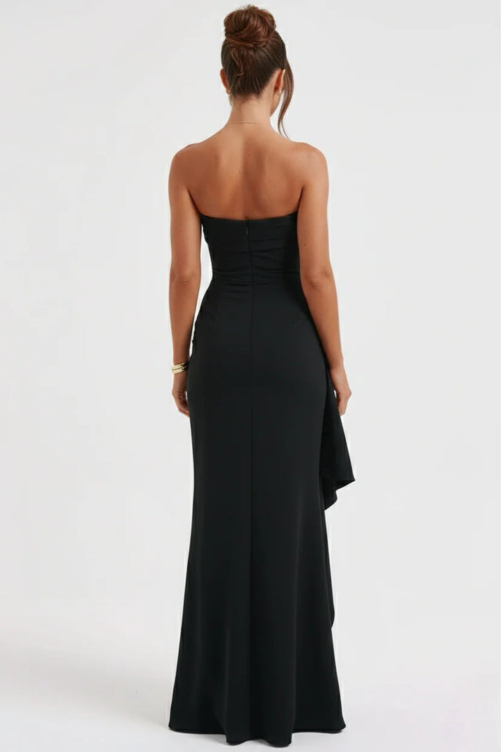 Side view of strapless maxi dress displaying dramatic thigh-high split with cascading ruffle accent