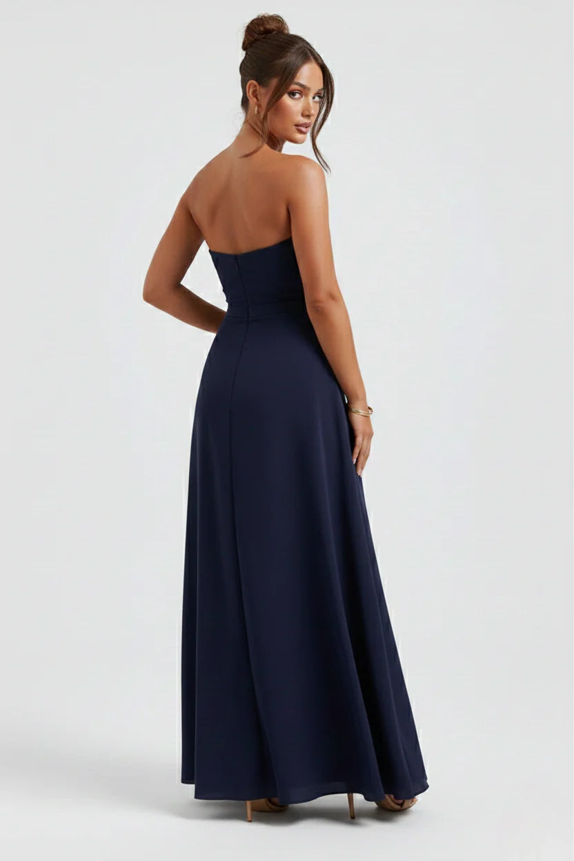 Model wearing strapless ruched maxi dress styled with strappy heels for evening event