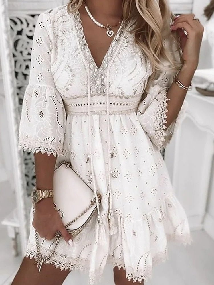 Full-length view of boho mini dress V-neck lace bell sleeves styled with accessories and handbag