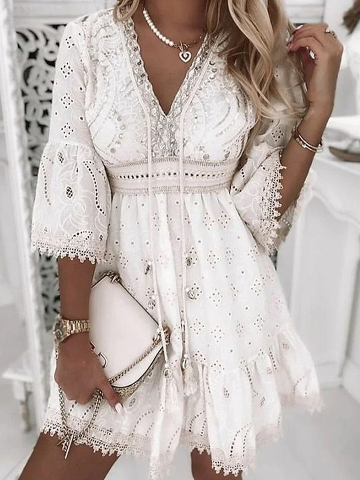 Full-length view of boho mini dress V-neck lace bell sleeves styled with accessories and handbag